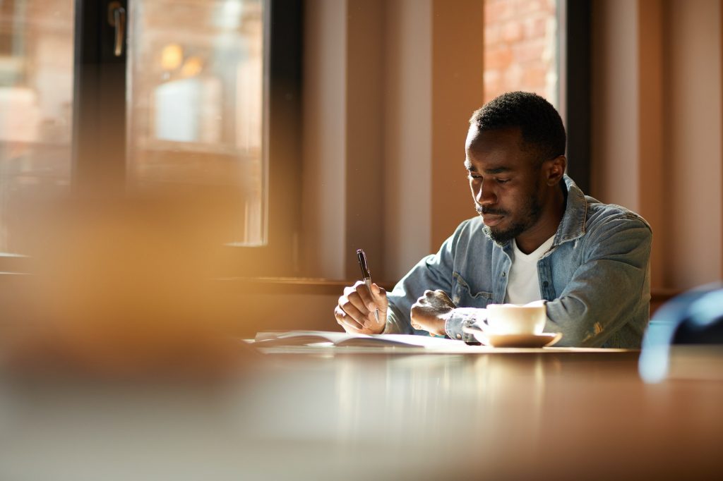 African man working at cafe